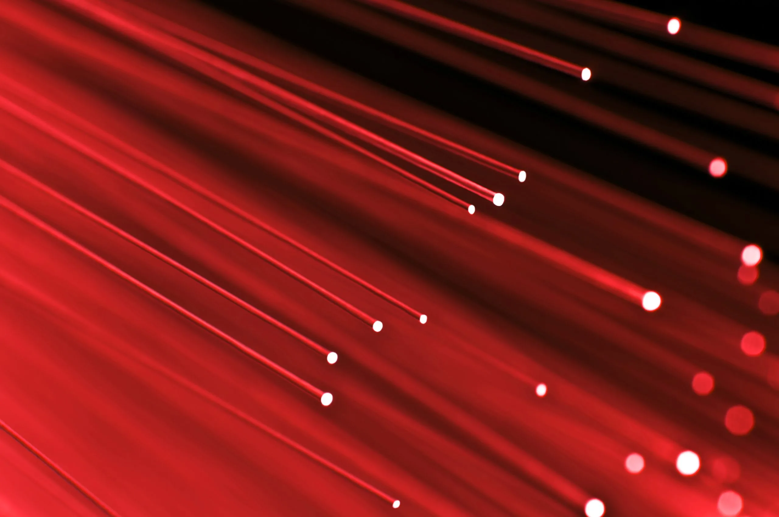 The image features red lights against a black background, creating an abstract and colorful visual effect.