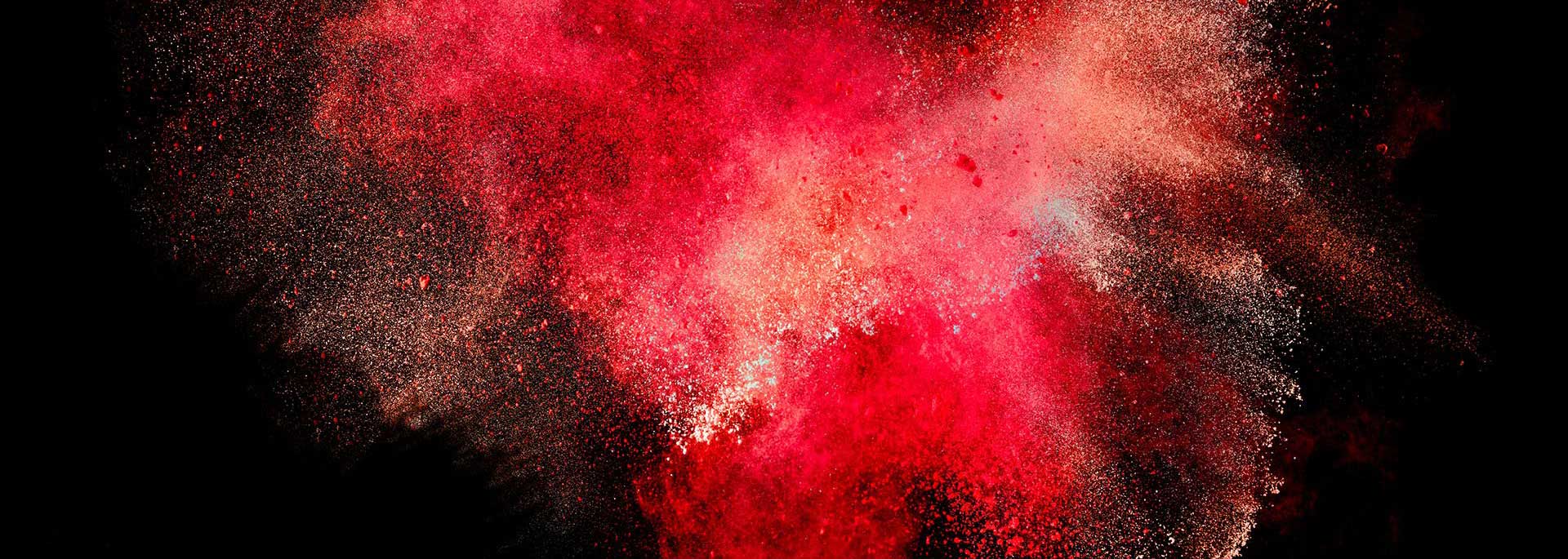 The image is a depiction of a red and black explosion, resembling fireworks or a nebula.