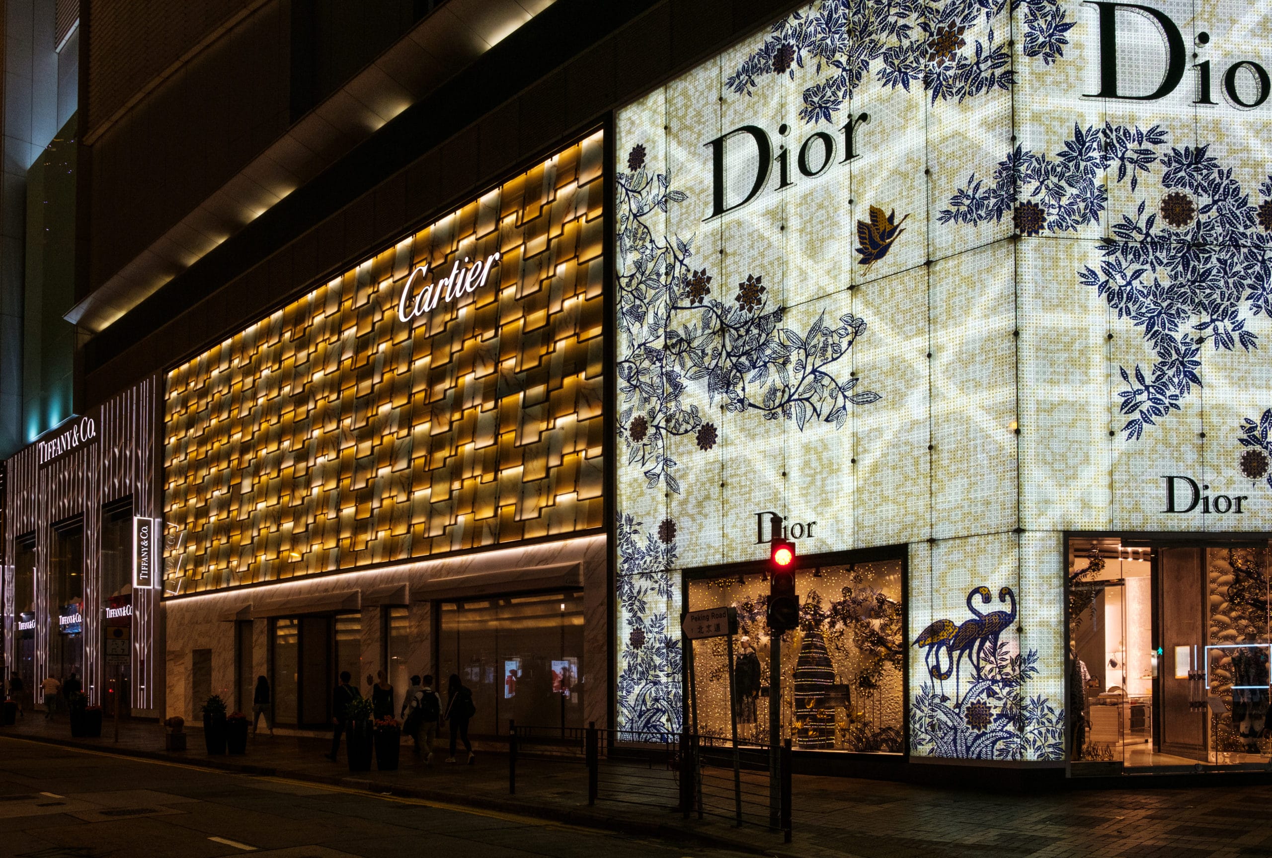 Store facades of luxury fashion brand shops in shopping area of Hongkong at night